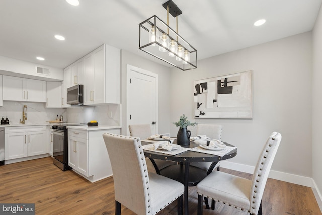 4536 Conwell Dr, Annandale, VA 22003 - dining room with recessed lighting, wood finished floors, and baseboards