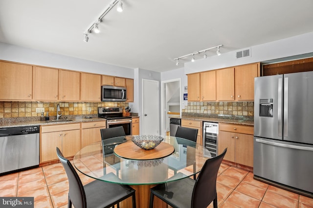 11212 Angus Pl, Potomac, MD 20854 - kitchen featuring appliances with stainless steel finishes, track lighting, wine cooler, and a sink
