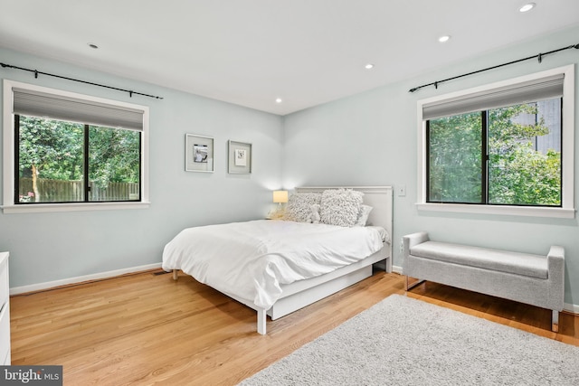 11212 Angus Pl, Potomac, MD 20854 - bedroom featuring multiple windows, wood finished floors, baseboards, and recessed lighting