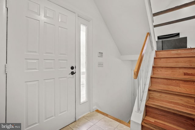 11212 Angus Pl, Potomac, MD 20854 - entryway featuring vaulted ceiling, light tile patterned flooring, stairs, and baseboards