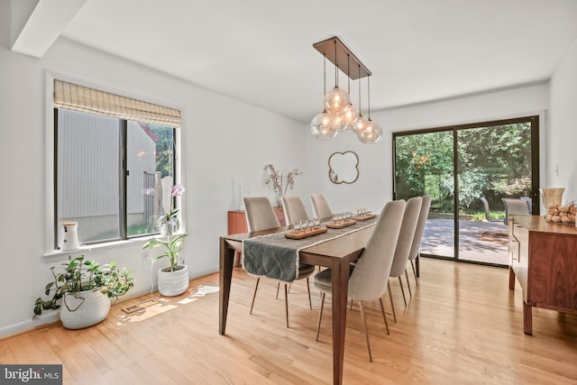 11212 Angus Pl, Potomac, MD 20854 - dining room featuring light wood finished floors and a chandelier