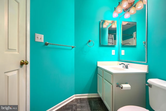 1713 Sea Pine Cir, Severn, MD 21144 - bathroom featuring toilet, vanity, and baseboards