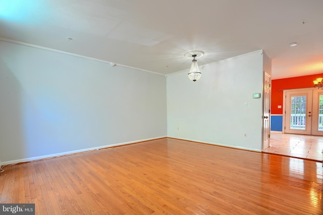 1713 Sea Pine Cir, Severn, MD 21144 - empty room with a chandelier, crown molding, light wood finished floors, and baseboards