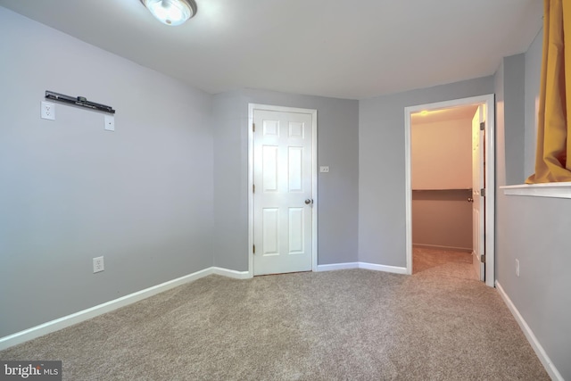 1713 Sea Pine Cir, Severn, MD 21144 - unfurnished bedroom with carpet flooring, baseboards, a walk in closet, and a closet