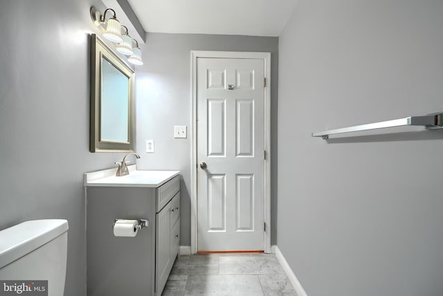 1713 Sea Pine Cir, Severn, MD 21144 - bathroom with toilet, vanity, and baseboards