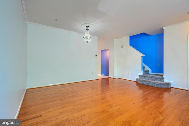 1713 Sea Pine Cir, Severn, MD 21144 - unfurnished living room with stairs, hardwood / wood-style flooring, crown molding, and baseboards