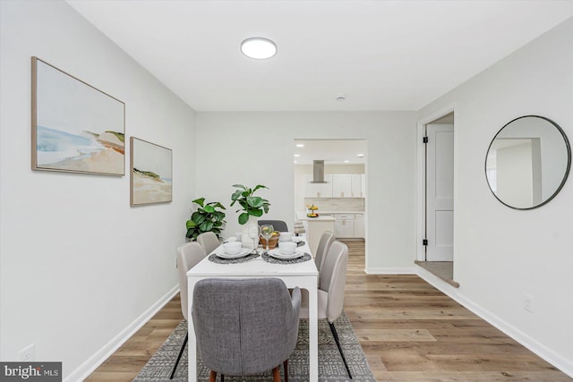 5507 Heatherwood Rd, Baltimore, MD 21227 - dining area with light wood-style flooring and baseboards