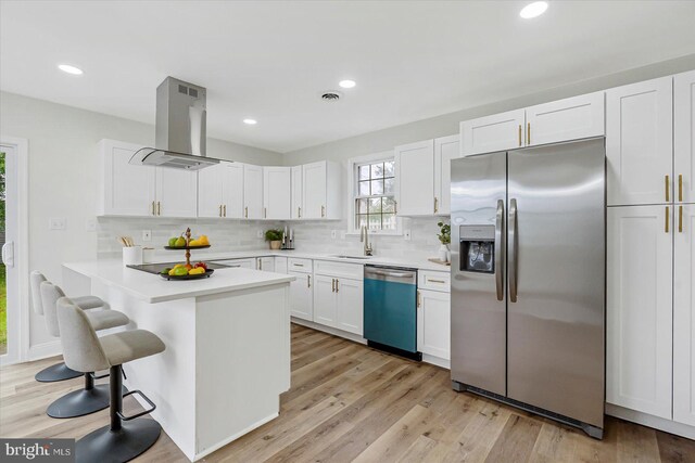 5507 Heatherwood Rd, Baltimore, MD 21227 - kitchen with stainless steel refrigerator with ice dispenser, dishwashing machine, island range hood, a sink, and a breakfast bar