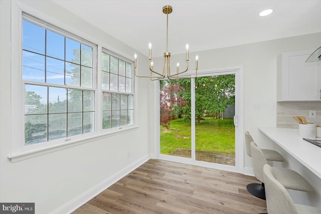 5507 Heatherwood Rd, Baltimore, MD 21227 - unfurnished dining area with baseboards, plenty of natural light, light wood-type flooring, and recessed lighting