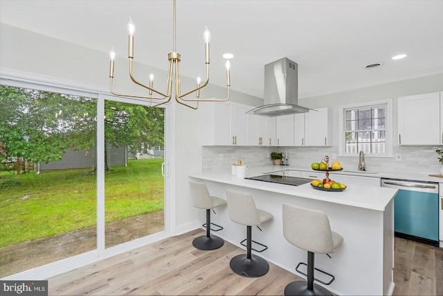5507 Heatherwood Rd, Baltimore, MD 21227 - kitchen featuring dishwasher, island range hood, backsplash, light countertops, and a chandelier