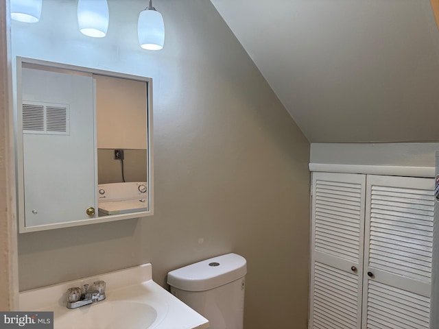 9200 Bridle Path Ln Unit E, Laurel, MD 20723 - bathroom featuring toilet, vanity, and lofted ceiling