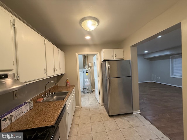 9200 Bridle Path Ln Unit E, Laurel, MD 20723 - kitchen with appliances with stainless steel finishes, a sink, water heater, white cabinetry, and light tile patterned flooring