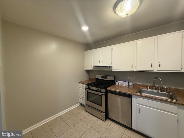 9200 Bridle Path Ln Unit E, Laurel, MD 20723 - kitchen featuring appliances with stainless steel finishes, a sink, under cabinet range hood, white cabinetry, and baseboards