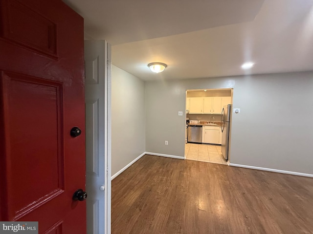 9200 Bridle Path Ln Unit E, Laurel, MD 20723 - empty room featuring wood finished floors, baseboards, and a sink