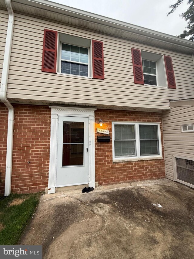 9200 Bridle Path Ln Unit E, Laurel, MD 20723 - view of front facade with brick siding and a patio area
