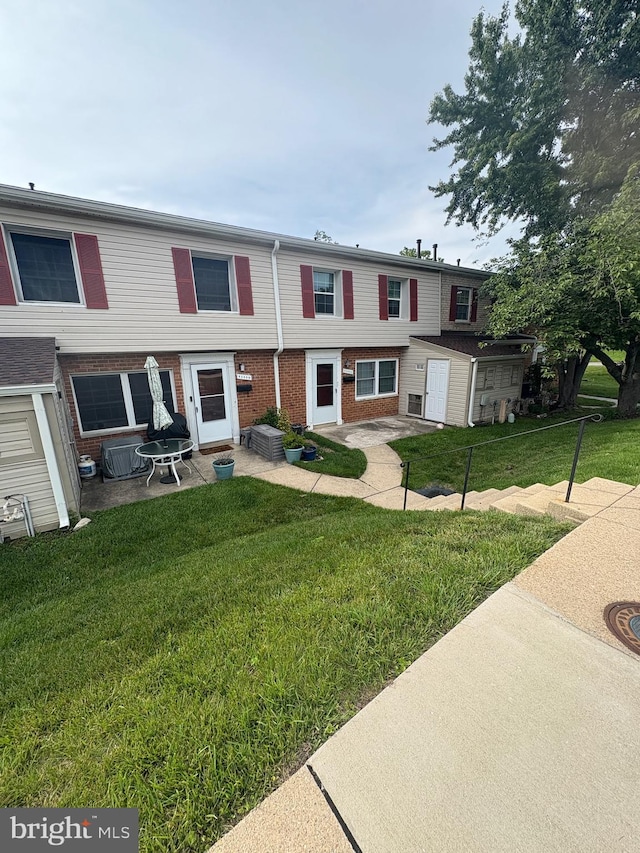 9200 Bridle Path Ln Unit E, Laurel, MD 20723 - multi unit property with brick siding, a front lawn, and a patio