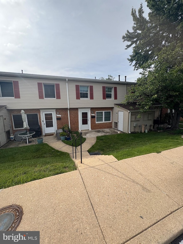 9200 Bridle Path Ln Unit E, Laurel, MD 20723 - rear view of house with brick siding and a lawn