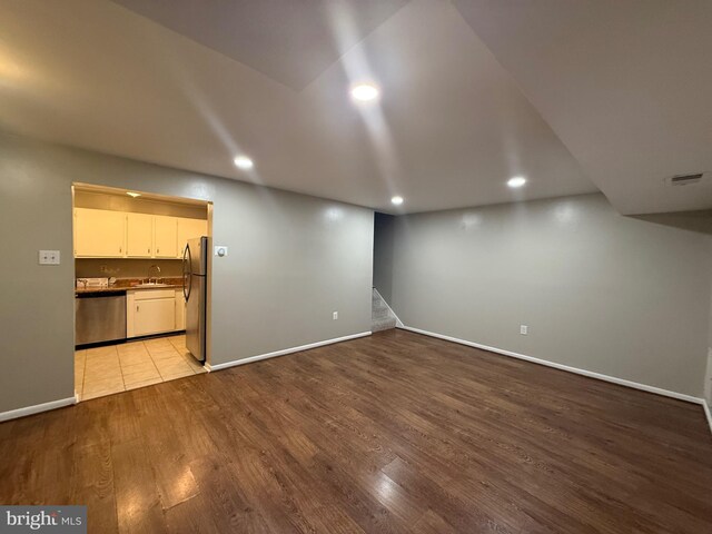 9200 Bridle Path Ln Unit E, Laurel, MD 20723 - unfurnished living room featuring wood finished floors, recessed lighting, stairway, baseboards, and a sink