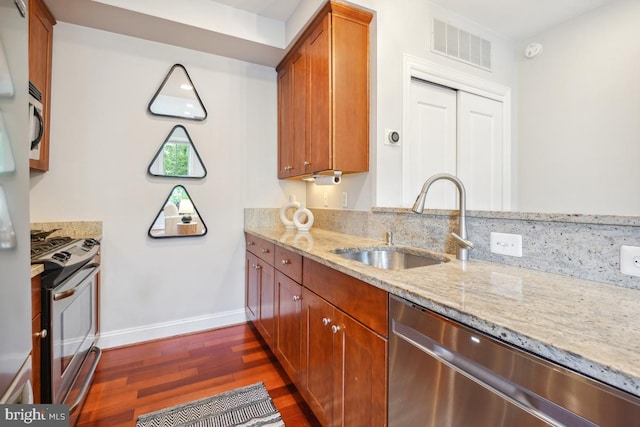 531 T St NW Unit 101, Washington, DC 20001 - kitchen featuring appliances with stainless steel finishes, a sink, dark wood finished floors, and light stone counters