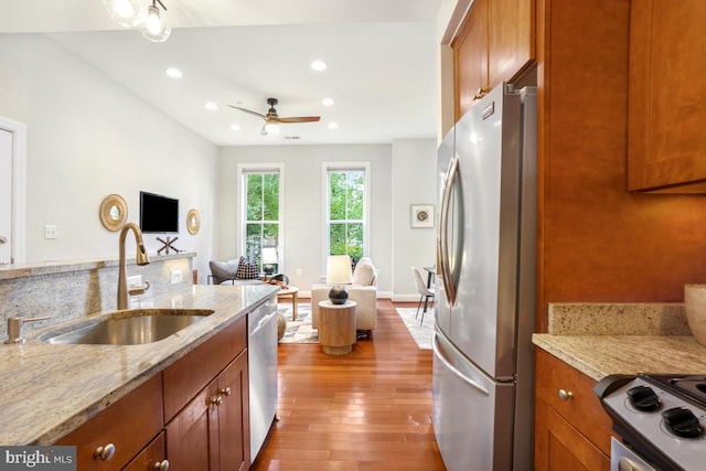 531 T St NW Unit 101, Washington, DC 20001 - kitchen with a sink, appliances with stainless steel finishes, open floor plan, brown cabinets, and wood finished floors