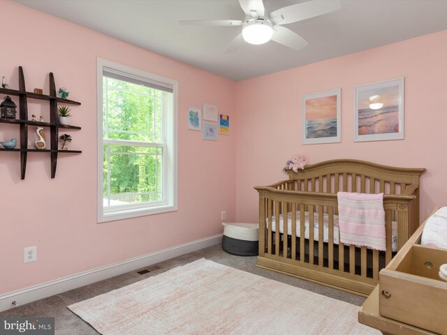 933 Winding Rd, Edgewater, MD 21037 - carpeted bedroom featuring a crib, baseboards, and ceiling fan