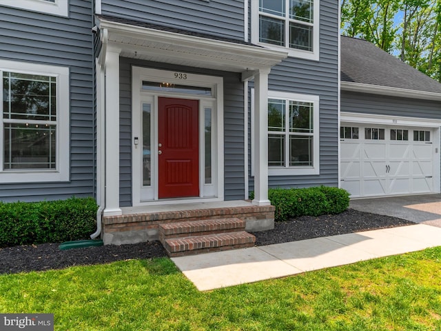 933 Winding Rd, Edgewater, MD 21037 - view of exterior entry with a garage, asphalt driveway, and roof with shingles