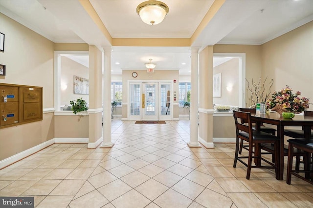 14040 New Acadia Ln Unit 408, Upper Marlboro, MD 20774 - dining space with ornate columns, light tile patterned floors, baseboards, and crown molding