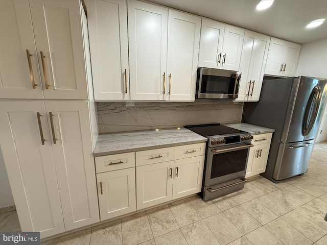 15 E Park Rd, Newtown, PA 18940 - kitchen with appliances with stainless steel finishes, tasteful backsplash, white cabinetry, and light stone countertops