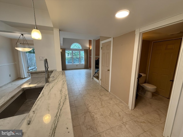 15 E Park Rd, Newtown, PA 18940 - kitchen with light stone counters and hanging light fixtures