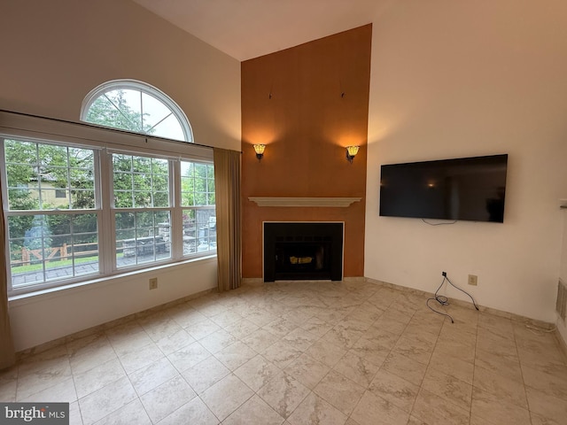 15 E Park Rd, Newtown, PA 18940 - unfurnished living room with healthy amount of natural light, a fireplace, a high ceiling, and tile patterned floors