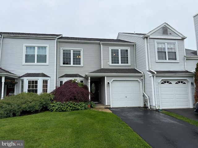 15 E Park Rd, Newtown, PA 18940 - view of property featuring a garage, asphalt driveway, and a front lawn