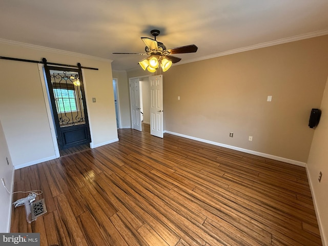 15 E Park Rd, Newtown, PA 18940 - unfurnished room with a barn door, wood finished floors, baseboards, ceiling fan, and ornamental molding