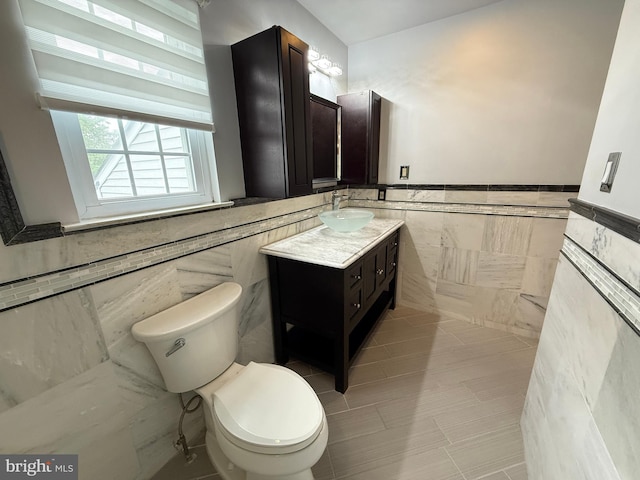 15 E Park Rd, Newtown, PA 18940 - half bathroom featuring tile walls, toilet, vanity, wainscoting, and tile patterned floors