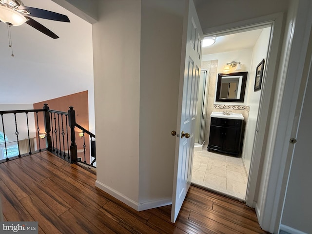 15 E Park Rd, Newtown, PA 18940 - hallway featuring an upstairs landing, hardwood / wood-style floors, a sink, and baseboards