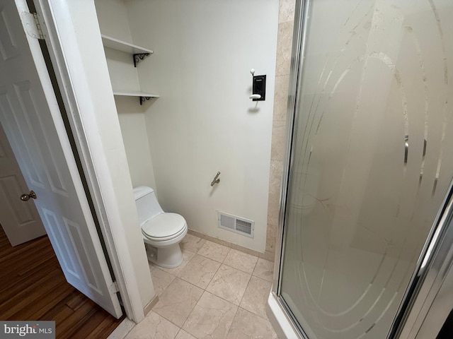 15 E Park Rd, Newtown, PA 18940 - bathroom with toilet, a shower stall, marble look tiles, and baseboards