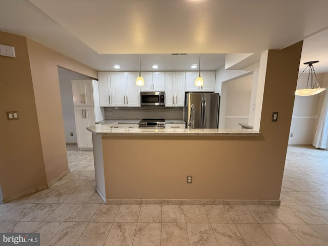 15 E Park Rd, Newtown, PA 18940 - kitchen with stainless steel appliances, white cabinetry, baseboards, and recessed lighting