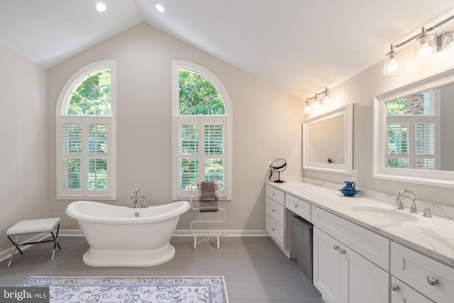4729 Grand Masters Way, Woodbridge, VA 22192 - bathroom featuring vaulted ceiling, vanity, a freestanding bath, and tile patterned floors