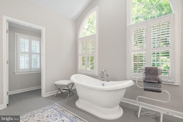 4729 Grand Masters Way, Woodbridge, VA 22192 - full bathroom featuring a soaking tub, tile patterned floors, and lofted ceiling