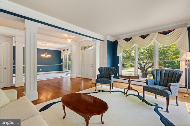 4729 Grand Masters Way, Woodbridge, VA 22192 - living area with ornate columns, crown molding, wood finished floors, baseboard heating, and a chandelier