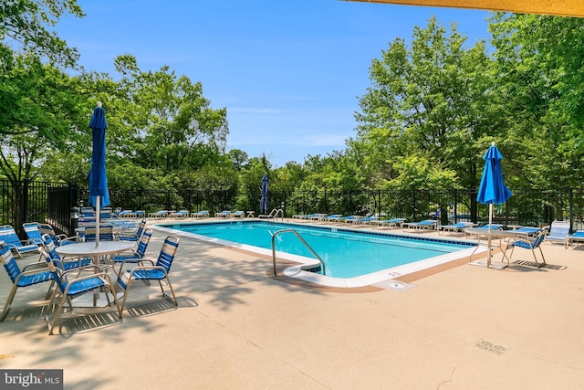 1276 N Wayne St Unit 300, Arlington, VA 22201 - community pool with a patio area and view of scattered trees