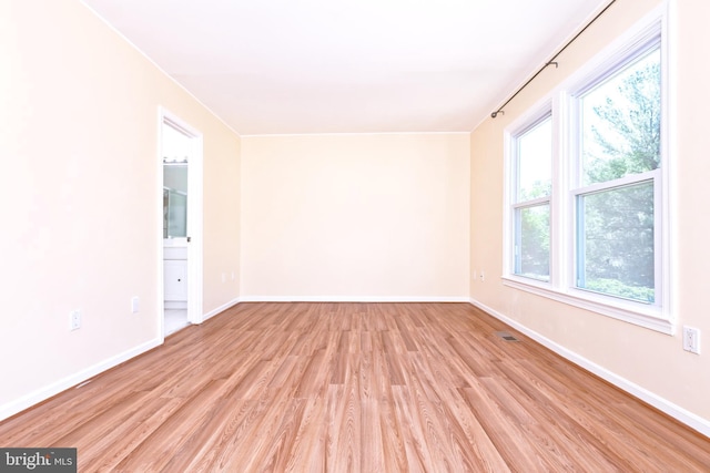 14520 Sorrento Ct, Burtonsville, MD 20866 - empty room featuring light wood-style floors, plenty of natural light, and baseboards