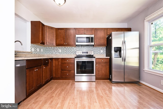 14520 Sorrento Ct, Burtonsville, MD 20866 - kitchen with stainless steel appliances, light wood-type flooring, healthy amount of natural light, and backsplash