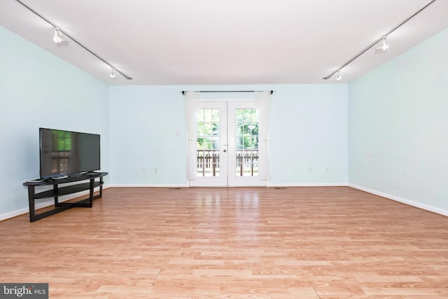 14520 Sorrento Ct, Burtonsville, MD 20866 - unfurnished living room featuring rail lighting, light wood finished floors, and baseboards