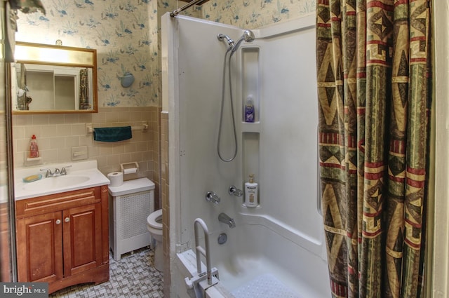 2828 Pelham Ave, Baltimore, MD 21213 - bathroom featuring wallpapered walls, wainscoting, toilet, vanity, and shower / tub combo