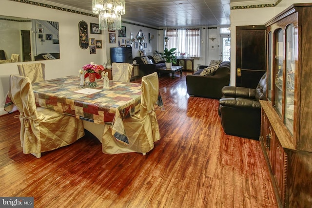 2828 Pelham Ave, Baltimore, MD 21213 - dining room featuring wood finished floors, crown molding, and a chandelier