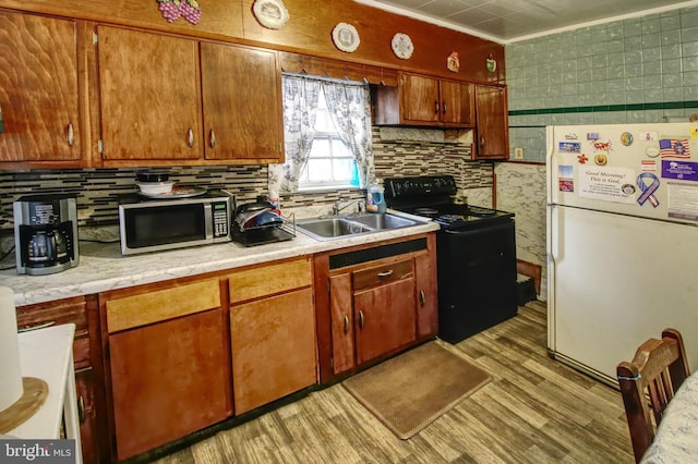 2828 Pelham Ave, Baltimore, MD 21213 - kitchen with freestanding refrigerator, electric range, stainless steel microwave, a sink, and light countertops