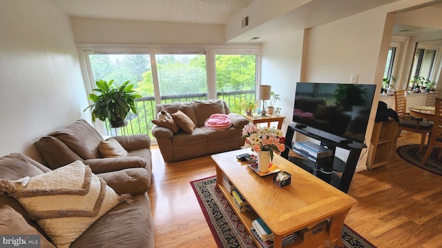 2921 N Leisure World Blvd Unit 418, Silver Spring, MD 20906 - living area featuring wood finished floors and a textured ceiling