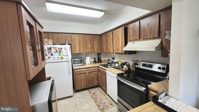 2921 N Leisure World Blvd Unit 418, Silver Spring, MD 20906 - kitchen featuring white appliances, under cabinet range hood, light countertops, brown cabinetry, and a textured ceiling