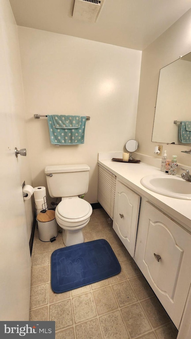 2921 N Leisure World Blvd Unit 418, Silver Spring, MD 20906 - bathroom featuring toilet, vanity, and tile patterned flooring