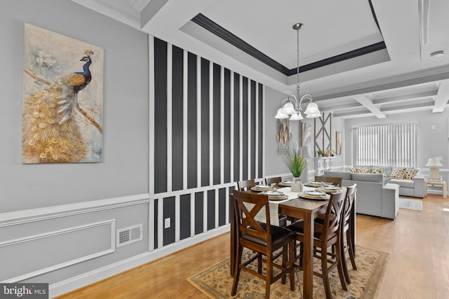 1330 Aisquith St, Baltimore, MD 21202 - dining area with light wood finished floors, a chandelier, beam ceiling, ornamental molding, and coffered ceiling